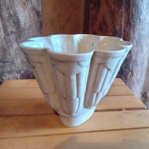 May include: A set of three ceramic mugs with a speckled, matte finish. The mugs are in shades of cream, light brown, and dark brown. Each mug has a simple, minimalist design, perfect for coffee or tea.