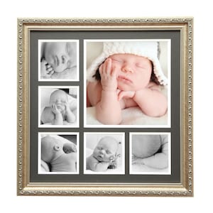 May include: A multi-photo picture frame with a gold-colored ornate border. The frame contains six black and white images of a sleeping baby wearing a white and gray hat. The frame is rectangular and sits on a white background.