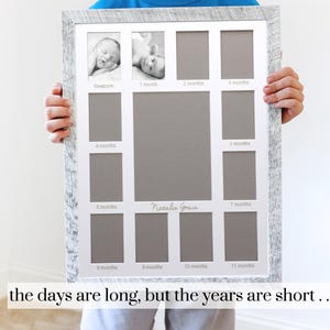May include: White wooden picture frame with 12 openings for photos. The frame has a distressed look and is designed to hold photos of a baby's first year. The frame has the words "Newborn", "1 month", "2 months", "3 months", "4 months", "5 months", "6 months", "7 months", "8 months", "9 months", "10 months", and "11 months" printed below each opening. The frame also has the name "Natalie Grace" printed in the center.
