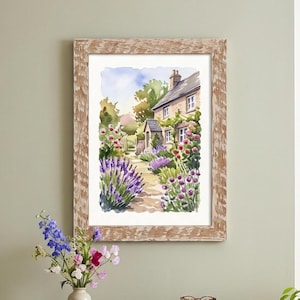 May include: Watercolor painting of a cottage garden in a rustic wooden frame. The artwork depicts a stone cottage with a path leading through a garden filled with lavender, pink, and red flowers. The sky is a soft blue.