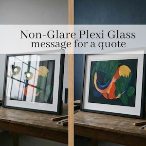 May include: Two framed art prints with black frames are displayed on a wooden table. The artwork features colorful abstract designs. The text "Non-Glare Plexi Glass message for a quote" is displayed across the top of the image.
