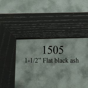 May include: A black wood picture frame with a 1-1/2 inch wide flat profile. The frame is labeled "1505" and "1-1/2" Flat black ash".