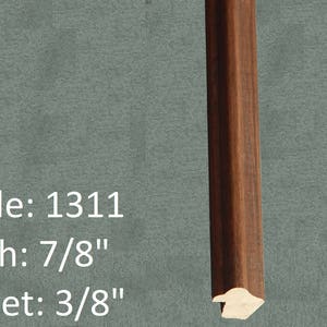 May include: A close-up of a dark brown wood picture frame with a profile number of 1311. The frame is 7/8 inches wide and has a 3/8 inch rabbet.