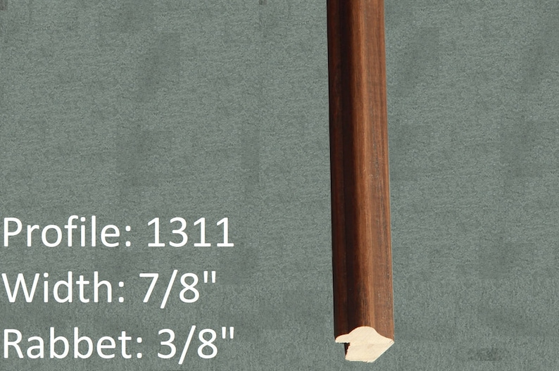 May include: A close-up of a dark brown wood picture frame with a profile number of 1311. The frame is 7/8 inches wide and has a 3/8 inch rabbet.