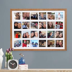 May include: A wooden framed collage of 24 small photos. The photos are of various people, in different settings. The frame is rectangular with a white border around the photos. The frame is hanging on a gray wall.