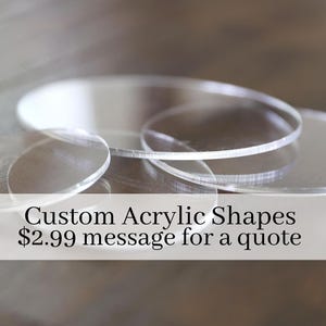 May include: Clear acrylic shapes in various sizes and thicknesses are displayed. The image includes the text "Custom Acrylic Shapes". The shapes are circular and appear to be custom-made. The background is blurred, emphasizing the acrylic pieces.