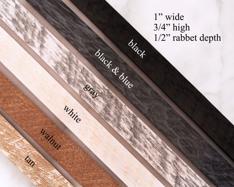 May include: A selection of wood picture frame samples in various colors, including tan, walnut, white, gray, black and blue, and black. The frames are 1 inch wide, 3/4 inch high, and have a 1/2 inch rabbet depth.