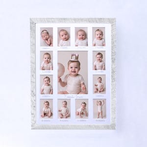 May include: A framed photo collage featuring a baby's first year, with individual photos for each month. The central image shows a smiling baby wearing a crown and holding a balloon. The frame is white with a textured finish.