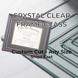 May include: A framed diploma from Pepperdine University with a dark brown frame. The text "CRYSTAL CLEAR FRAME GLASS" is at the top, and "Custom Cut • Any Size" is at the bottom. Several sheets of clear glass are in the background.
