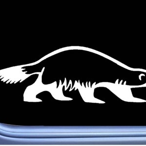 May include: A white silhouette of a wolverine walking to the right. The wolverine is facing forward with its head turned slightly to the right. The wolverine has a long, bushy tail.