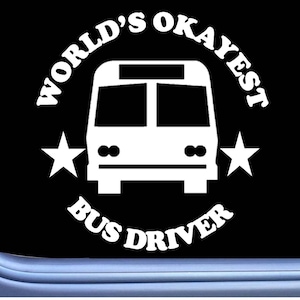 May include: White vinyl decal with the text "World's Okayest Bus Driver" in a curved arc around a white silhouette of a bus. Two white stars are on either side of the bus.