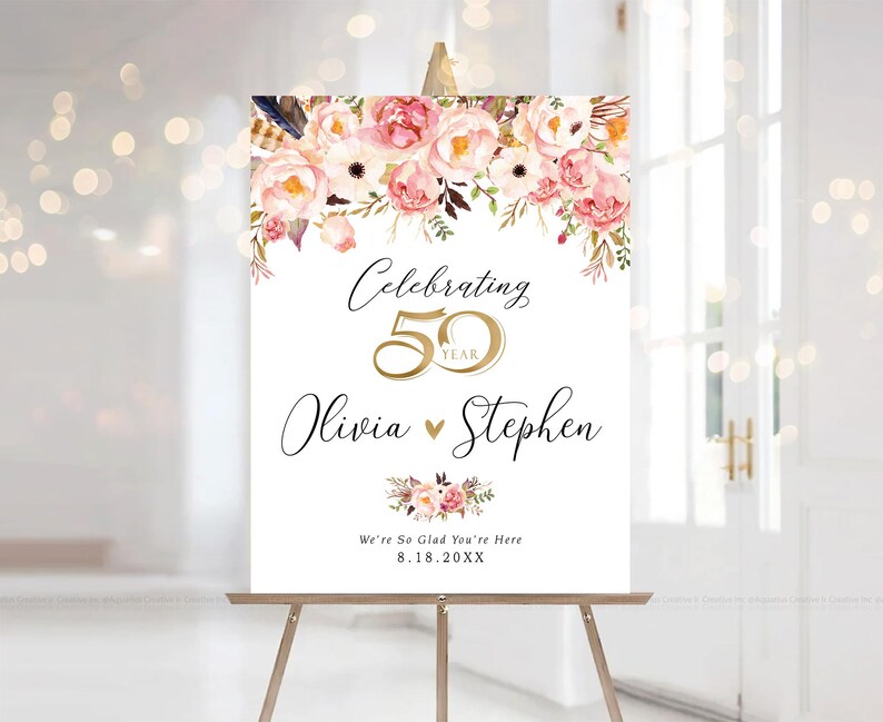 May include: A white sign on a wooden easel, with floral arrangements and text. The sign reads "Celebrating 50 Year" with the names "Olivia" and "Stephen" below. The date "8.18.20XX" is also included.