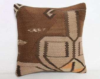 May include: A brown and beige patterned throw pillow with a geometric design. The pillow is made of woven fabric and has a soft, textured surface.