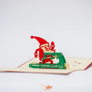 Biglietto pop-up con Babbo Natale che fa esercizi