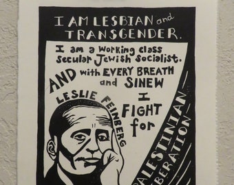 May include: Black and white print with text: "I AM LESBIAN and TRANSGENDER. I am a Working class Secular Jewish Socialist. AND with EVERY BREATH and SINEW I FIGHT for PALESTINIAN LIBERATION." Image of Leslie Feinberg.