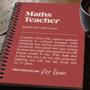 May include: A red spiral-bound notebook featuring the white text Maths Teacher, a phonetic pronunciation, and a humorous definition. The cover includes the phrase Also known as: Mr Kane. The notebook is positioned next to a black coffee mug.