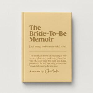 May include: A hardcover book with a light yellow cover and dark brown text. The title reads The Bride-To-Be Memoir, followed by a phonetic pronunciation, a definition of the term, and the text A memoir by: Charlotte in a script font.