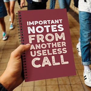 May include: A maroon spiral-bound notebook featuring the white text "IMPORTANT NOTES FROM ANOTHER USELESS CALL" printed in a bold, sans-serif font on the front cover. The notebook has a black metal coil binding along the left side.
