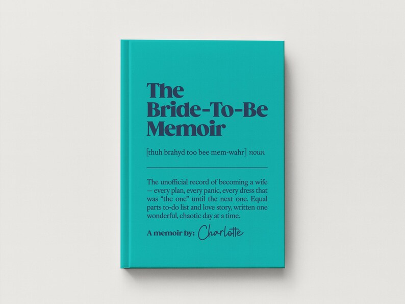May include: A teal hardcover book titled The Bride-To-Be Memoir with dark blue text. The cover includes a phonetic pronunciation, a definition of the title, and the text A memoir by: Charlotte in a script font at the bottom of the front cover.