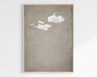 May include: A framed print of a minimalist abstract art piece featuring a single white cloud against a light brown background.