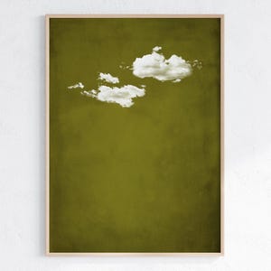 May include: A framed print of a minimalist abstract art piece featuring a single white cloud against a solid olive green background.