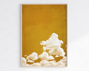 May include: A digital art print featuring a yellow background with white clouds. The clouds are clustered together in the bottom right corner of the print.