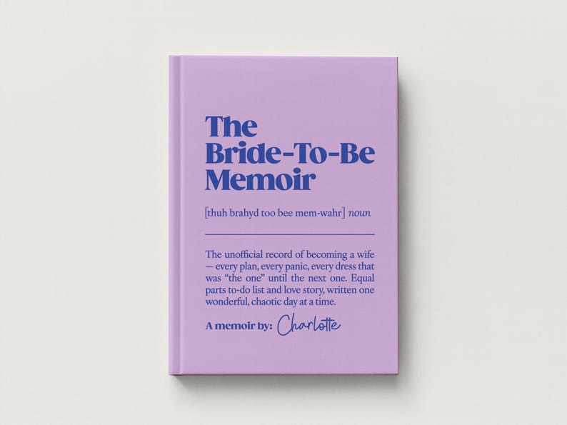 May include: A light purple book titled The Bride-To-Be Memoir with dark blue text. The cover includes a phonetic pronunciation, the noun definition, and the phrase A memoir by: Charlotte in a script font, describing a record of becoming a wife.