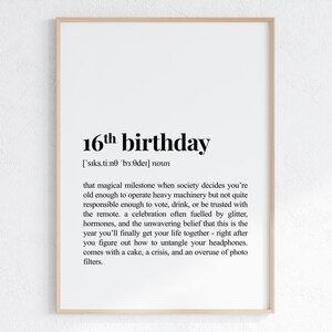 May include: A framed print with the text "16th birthday" in a bold, black font. The definition below humorously describes the milestone. The print is in a light wood frame, set against a white background.