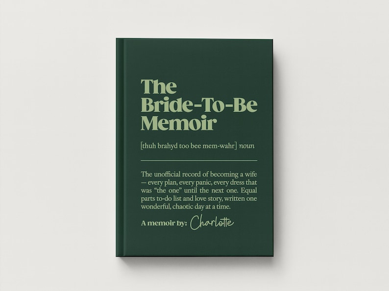 May include: A dark green hardcover book titled The Bride-To-Be Memoir with light green text. The cover includes a phonetic pronunciation, the noun definition, and the text A memoir by: Charlotte in a script font centered on the front cover.