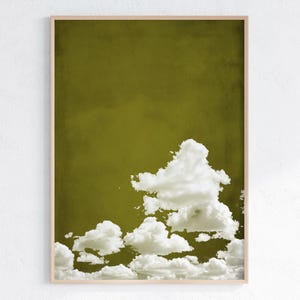 May include: A digital art print featuring a stylized image of white clouds against a solid olive green background.