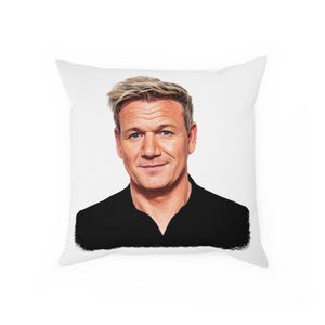 May include: A white throw pillow with a color illustration of a man with blond hair wearing a black collared shirt. The man is smiling and looking directly at the viewer.