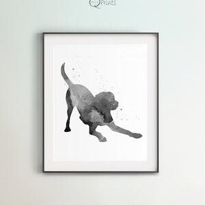 May include: Black and white watercolour painting of a dog stretching. The dog is in silhouette with a few watercolour splatters around it.