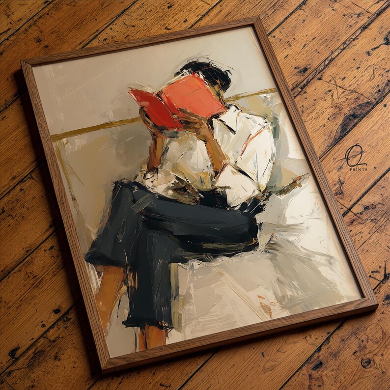 May include: A framed art print depicts a person absorbed in reading a book. The artwork features a person in a white shirt and dark pants, with a bright red book. The print is in a wooden frame, with the artist's logo in the bottom right corner.