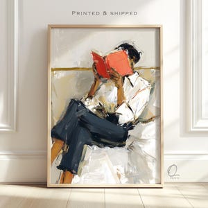 May include: Abstract art print of a person reading a book. The person is wearing a white shirt and dark blue pants. The book is open, with bright orange pages. The artwork is in a wooden frame, with the text "PRINTED & SHIPPED" at the top.