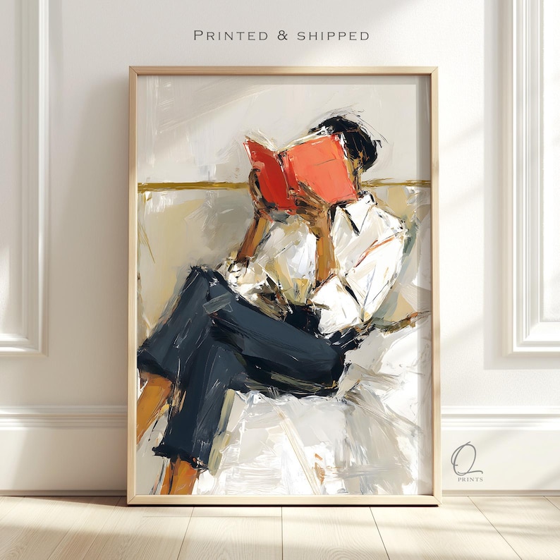 May include: Abstract art print of a person reading a book. The person is wearing a white shirt and dark blue pants. The book is open, with bright orange pages. The artwork is in a wooden frame, with the text "PRINTED & SHIPPED" at the top.