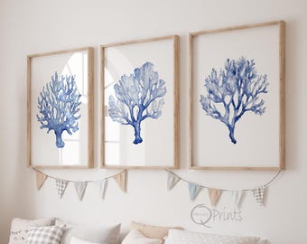 May include: Three framed prints of blue watercolour coral on a white background. The frames are light wood and the prints are arranged in a row.