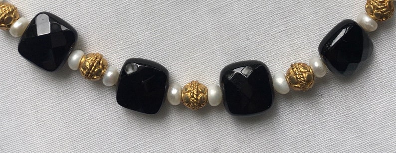 Onyx Vermeil and pearl.