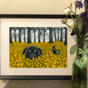 May include: A black and white illustration of a furry creature with a big smile, peeking out from a field of yellow flowers. A blue butterfly flies above the flowers. The background shows a dark forest with a crescent moon in the sky.