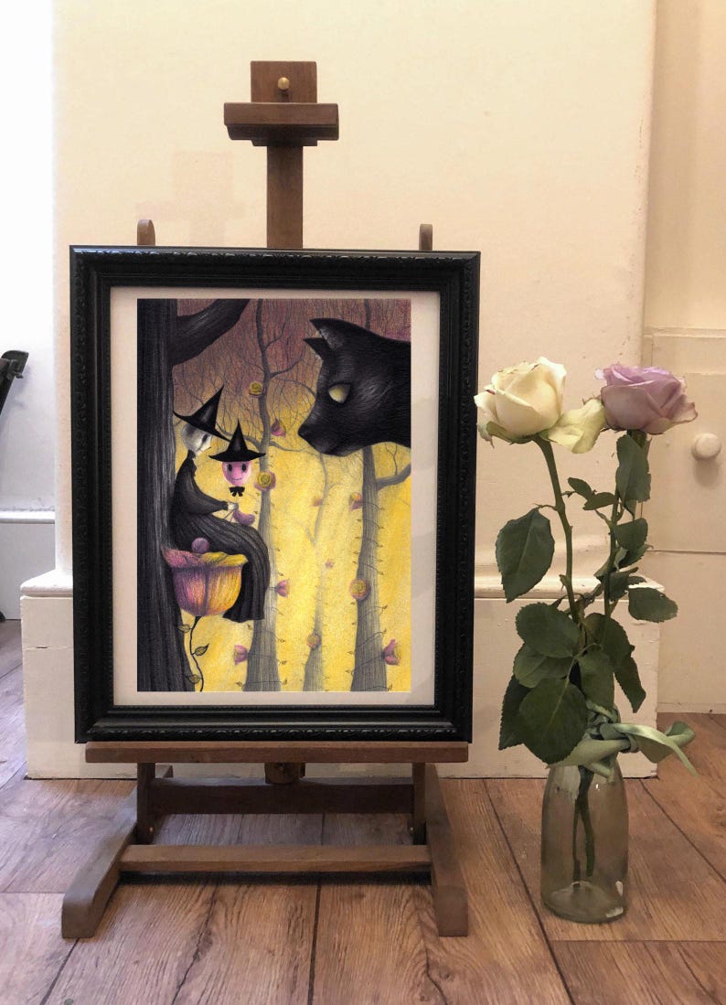 May include: A framed illustration of two witches sitting on a flower in a forest with a black cat watching them. The witches are wearing black hats and dresses. The forest is filled with yellow flowers and trees.