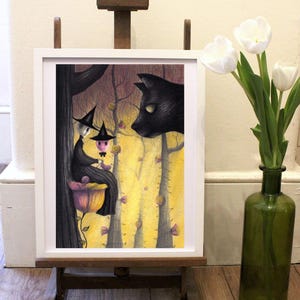 May include: A framed illustration of two witches sitting on a flower in a forest with a black cat looking at them. The witches are wearing black hats and dresses. The forest is filled with yellow and pink flowers.
