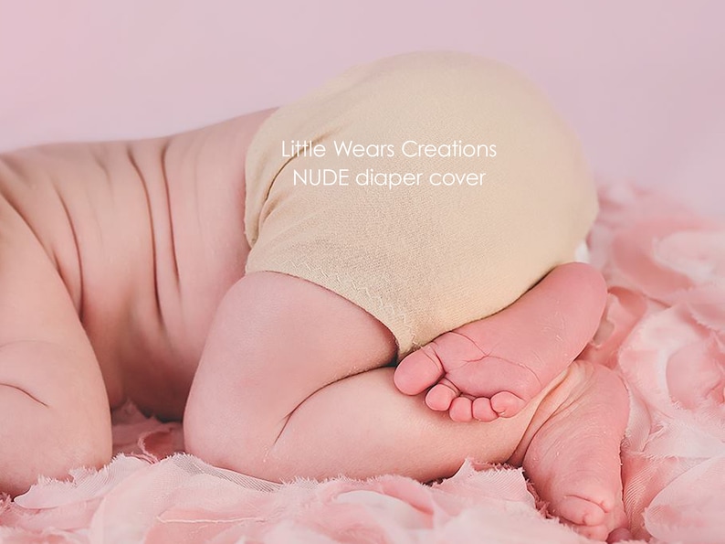 A newborn baby is wearing a nude skin colour diaper / nappy cover over a diaper. These covers are handmade by Little Wears Creations and an Etsy Bestseller. They are perfect for covering up the diaper, and a must have item for newborn photography.