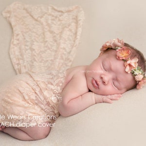 A newborn baby is wearing a nude skin colour diaper / nappy cover over a diaper. These covers are handmade by Little Wears Creations and an Etsy Bestseller. They are perfect for covering up the diaper, and a must have item for newborn photography.