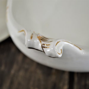 Close up of a handle showing the hand painted gold trim.