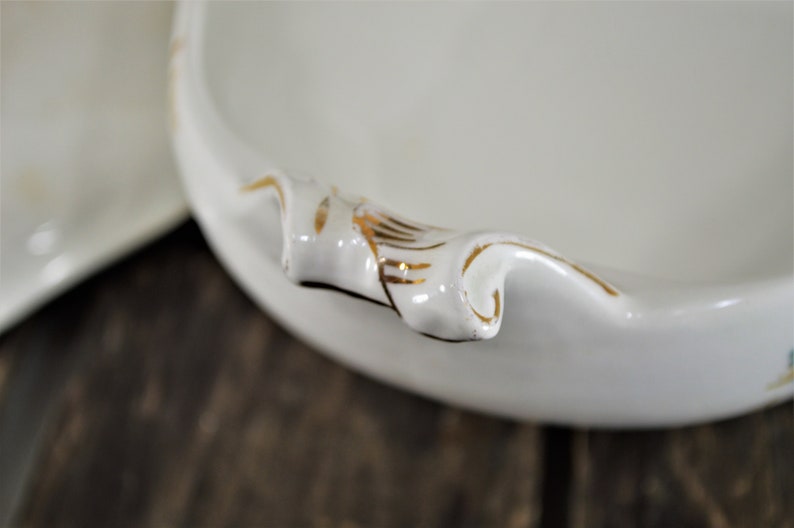 Close up of a handle showing the hand painted gold trim.