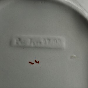 Picture of the possible run number and date or serial numbers on the bottom of the dish.