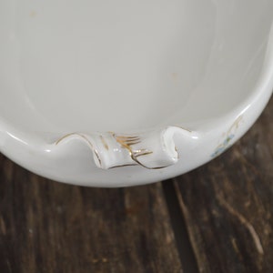 Close up of a handle showing the hand painted gold trim.