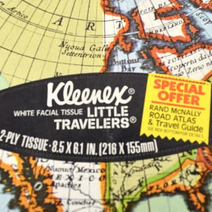 May include: A box of Kleenex facial tissues with a map design. The black label reads "Kleenex Little Travelers" and includes the dimensions 8.5 x 6.1 inches. A yellow "Special Offer" sticker is also visible.
