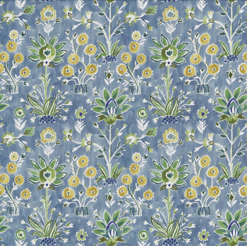 May include: A repeating pattern of stylized floral elements in shades of green, yellow, and blue. The design features symmetrical arrangements of flowers and foliage against a textured blue background, creating a watercolor effect. The pattern is suitable for fabric or wallpaper.