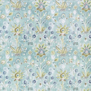 May include: A repeating pattern of stylized floral elements in shades of blue, green, and brown on a light blue background. The design features large, symmetrical flower shapes and smaller floral accents, creating a textured, watercolor effect.