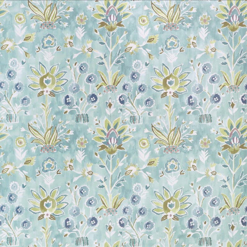 May include: A repeating pattern of stylized floral elements in shades of blue, green, and brown on a light blue background. The design features large, symmetrical flower shapes and smaller floral accents, creating a textured, watercolor effect.